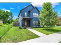 Attractive blue home with a tidy lawn and sidewalk, showcasing a well-maintained property with inviting curb appeal at 2720 Guilford Ave, Indianapolis, IN 46205
