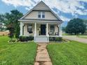 Inviting two-story home with a well-manicured lawn and a stone pathway leading to the front door at 3015 Mckinley Ave, Columbus, IN 47201