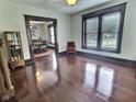Spacious living room with gleaming hardwood floors, detailed trim, and an abundance of natural light at 3015 Mckinley Ave, Columbus, IN 47201