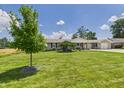 Well-maintained ranch-style home on a spacious lot with mature trees and manicured lawn at 4511 W 300 S, Anderson, IN 46011