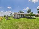 Beautiful ranch home featuring lovely landscaping, a brick exterior, and a serene country setting at 4511 W 300 S, Anderson, IN 46011
