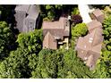 Aerial shot of a home with a large deck, lush landscaping, mature trees, and a private driveway at 5240 Windridge Dr, Indianapolis, IN 46226