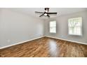 Bright bedroom with hardwood floors, ceiling fan, and natural light from two windows at 5759 Columbia S Cir, Greenwood, IN 46142