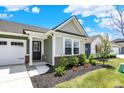 Charming home entrance with a black front door, detailed trim, and beautiful landscaping at 843 Garrow Dr, Westfield, IN 46074