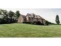 Well-maintained home with manicured lawn and mature trees, offering a serene and inviting atmosphere at 8785 W 100 N, Anderson, IN 46011