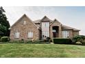 Lovely two-story home with a brick facade, enhanced by colorful landscaping and a well-kept lawn at 8785 W 100 N, Anderson, IN 46011