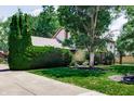 Pleasant front exterior featuring a stone accent wall, mature landscaping, and a well-maintained lawn at 919 Dreamy St, Greenwood, IN 46142