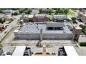 Aerial view of parking garage featuring solar panels in a commercial and residential district at 925 Veterans Way # 101, Carmel, IN 46032