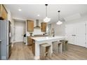 Well-designed kitchen with an island, wooden cabinets, stainless steel appliances, and pendant lighting at 9737 Oleander Dr, Fishers, IN 46250