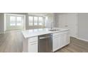 Modern kitchen with stainless steel appliances and white cabinets, featuring a large island with a sink and ample countertop space at 9751 Behner Dr, Fishers, IN 46250