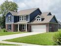Charming two-story home featuring a brick and blue wood facade, with a well-manicured lawn at 980 S Raylee Garden Dr, New Palestine, IN 46163