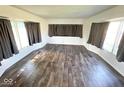 Spacious living room filled with lots of natural light and beautiful wood flooring at 10 Lincoln Cir, Elwood, IN 46036