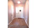 Inviting foyer featuring wood-look flooring and a charming 'Welcome Home' sign at 10178 Cornith Way, Avon, IN 46123
