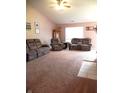 Spacious living room featuring a vaulted ceiling, plush carpeting, and comfortable seating at 10178 Cornith Way, Avon, IN 46123