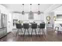 Modern kitchen with white cabinets, stainless steel appliances, a central island with seating, and pendant lighting at 10262 Rieslaner Cir, Zionsville, IN 46077