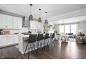 Open-concept kitchen featuring an island with barstool seating, pendant lighting, and stainless steel appliances at 10262 Rieslaner Cir, Zionsville, IN 46077