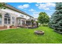 Expansive backyard with a deck, screened porch, fire pit, and mature landscaping at 10587 Proposal Pointe Way, Fishers, IN 46040