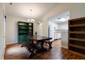 Bright dining area with wooden floors, stylish chandelier, and easy access to the kitchen at 1059 Wild Ivy Trl, Franklin, IN 46131