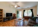 Cozy living room with hardwood floors, a ceiling fan, and plenty of natural light at 1059 Wild Ivy Trl, Franklin, IN 46131