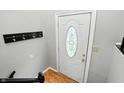 Bright entryway featuring a white door with decorative oval glass, complemented by light wood floors at 1103 Rosengarten Dr, Greenwood, IN 46142