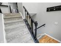 Carpeted staircase with black railings leading to the upper level, and light colored walls at 1103 Rosengarten Dr, Greenwood, IN 46142