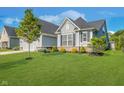 Well-maintained home exterior with green lawn, shrubbery and mature tree at 12634 Mustard Seed Ct, Fishers, IN 46038
