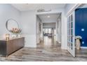 Open foyer with hardwood floors, neutral walls and decorative accents at 12634 Mustard Seed Ct, Fishers, IN 46038