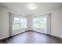 Bright bedroom features hardwood floors, white walls, and large windows with elegant white curtains at 1336 Danielle Rd, Lebanon, IN 46052