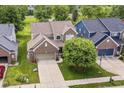 Aerial view of a neighborhood showcasing this property, with a well-maintained lawn, mature trees, and more at 13700 Stanford Dr, Carmel, IN 46074