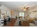 Staged living room with hardwood floors, cozy seating arrangement, and natural light from the window at 14523 Lee Stewart Ln, Fishers, IN 46038