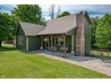 Charming home with a cozy covered porch, brick chimney, complemented by mature trees at 155 Hoover Dr, , IN 46164
