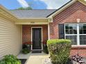Inviting front entrance with a black door, decorative plants, and visible house number at 1820 Irish Lake Ln, Indianapolis, IN 46239