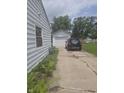 View of driveway and detached garage alongside house showing exterior siding at 206 Allen Ln, Greenfield, IN 46140