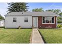 A cozy, well-maintained home with a mix of white siding and red cedar shake, complemented by flower boxes and a neat lawn at 206 Allen Ln, Greenfield, IN 46140