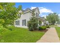 Well-maintained two-story house with a classic design, green lawn and sidewalk at 211 N County Line Rd, , IN 47272
