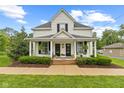 Inviting two-story home with covered porch, hanging swing, and landscaped front yard at 211 N County Line Rd, , IN 47272