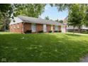 Well-maintained brick house with a green lawn and mature trees at 220 E Tilden Dr, Brownsburg, IN 46112