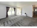 Bright living room with gray carpeting and fresh neutral paint at 220 E Tilden Dr, Brownsburg, IN 46112