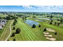 Aerial view of a lush golf course community with ponds, green fairways, and beautiful homes at 2251 Somerset Dr, Franklin, IN 46131