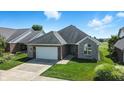 Charming single-story home with a brick and stone facade, well-manicured lawn, and a two-car garage at 2251 Somerset Dr, Franklin, IN 46131