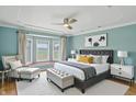 Spacious main bedroom featuring a tray ceiling, stylish furnishings, and a cozy bay window at 2251 Somerset Dr, Franklin, IN 46131