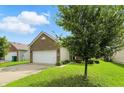 Lovely home featuring a two-car garage, nice lawn, and mature trees at 2253 Bridlewood Dr, Franklin, IN 46131