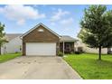 Charming brick home featuring a two-car garage and a well-maintained front lawn at 2253 Bridlewood Dr, Franklin, IN 46131