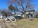 A landscape shot of the home with a detached garage at 2519 N A St, Elwood, IN 46036