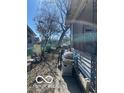 View of the house side yard with patio furniture and grill at 2519 N A St, Elwood, IN 46036