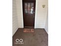 Inviting front entrance featuring a wooden door and a 'Home Sweet Home' welcome mat at 2830 Guilford Ave, Indianapolis, IN 46205