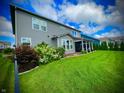 Expansive backyard with lush green lawn, mature trees, and a covered patio for outdoor entertaining at 4281 Viewforth Ln, Bargersville, IN 46106