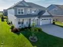 Charming two-story home boasts beautiful landscaping, a lush lawn, and a convenient two-car garage at 4281 Viewforth Ln, Bargersville, IN 46106