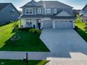 Inviting two-story home featuring a well-manicured lawn, spacious driveway, and a charming two-car garage at 4281 Viewforth Ln, Bargersville, IN 46106