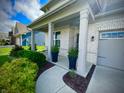 Welcoming front porch with decorative columns, potted plants, and a walkway leading to the front door at 4281 Viewforth Ln, Bargersville, IN 46106